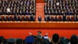 A conductor leads an orchestra as delegates stand for the national anthem during the closing session of the 19th National Congress of the Communist Party of China at the Great Hall of the People in Beijing, Oct. 24, 2017. 