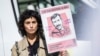 FILE - Actor Barbara Pravi holds a placard that reads "Stop executions in Iran" during a march in Paris on the second anniversary of a protest movement sparked by the death in morality police custody of Mahsa Amini, Sept. 15, 2024.