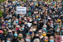 Demonstrators gather at a rally to peacefully protest and demand an end to institutional racism and police brutality, June 3, 2020, in Portland, Maine.