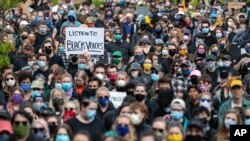 Protesters Sing "We Shall Overcome" as Officer Charges Amended