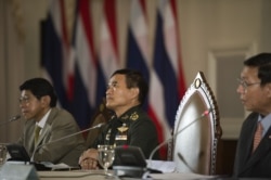 FILE - Members of the National Council for Peace and Order, from left, Wissanu Krea-ngam, General Paiboon Khumchaya and Pornpetch Wichitcholchai speak during a press conference at Government House in Bangkok, July 23, 2014.