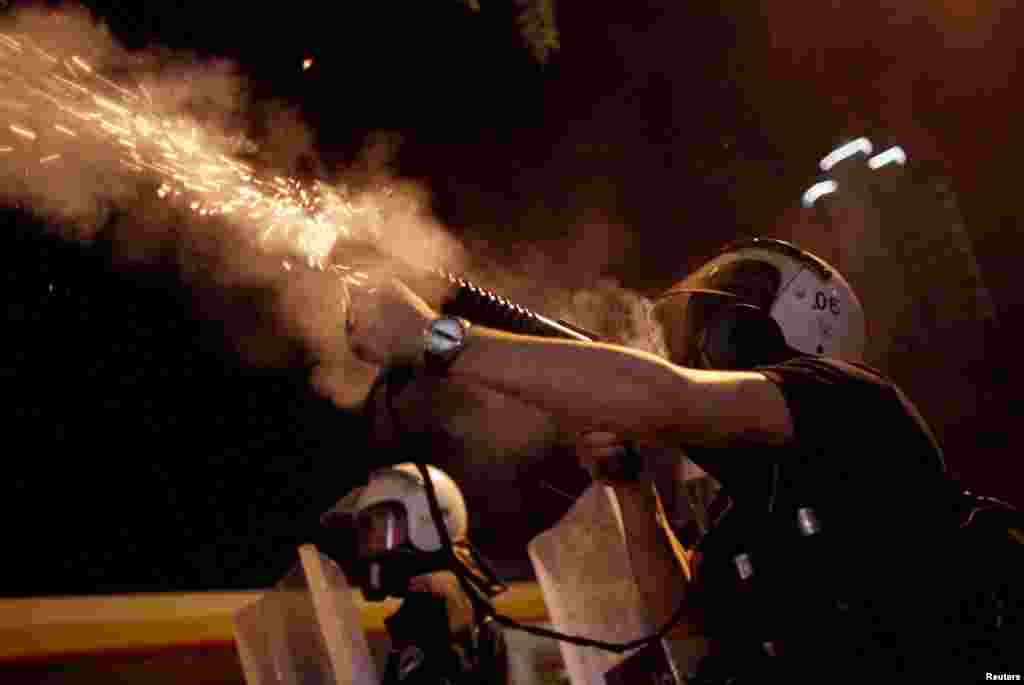 Riot police fire tear gas toward protesters during clashes in Kennedy Street in central Ankara, Turkey, June 18, 2013.