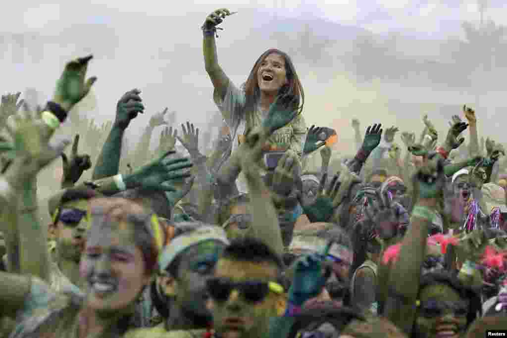 Participants cheer as they take part in The Color Run in Cali, Colombia, Nov. 3, 2013. The Color Run is a five-kilometer, untimed race, held in cities worldwide, with the aim of promoting healthy living. Participants are doused from head to toe in different colors at each kilometer.