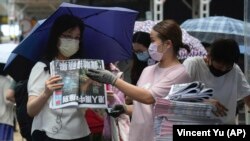 Orang-orang antre untuk membeli edisi terakhir koran Apple Daily di sebuah kios di pusat kota Hong Kong, Kamis, 24 Juni 2021. (Foto: Vincent Yu/AP Photo)