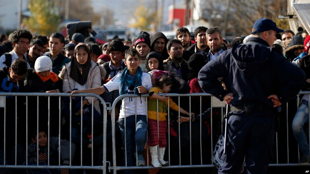 Migrants wait to register with police at a refugee center in the southern Serbian town of Presevo, Nov. 16, 2015.