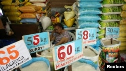 A vendor rests in her market stand that sells rice in Quezon City, Metro Manila in Philippines, Sept. 5, 2018.