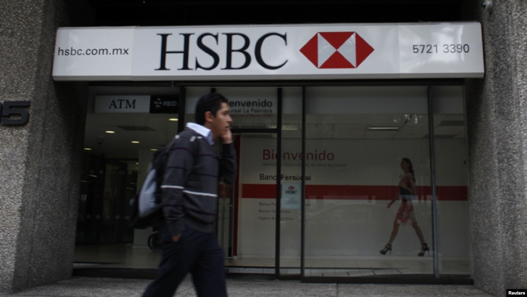 FILE - A man walks past a HSBC branch in Mexico City.
