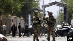 FILE - Resolute Support (RS) forces arrive at the site of car bomb explosion in Kabul, Afghanistan, Sept. 5, 2019.
