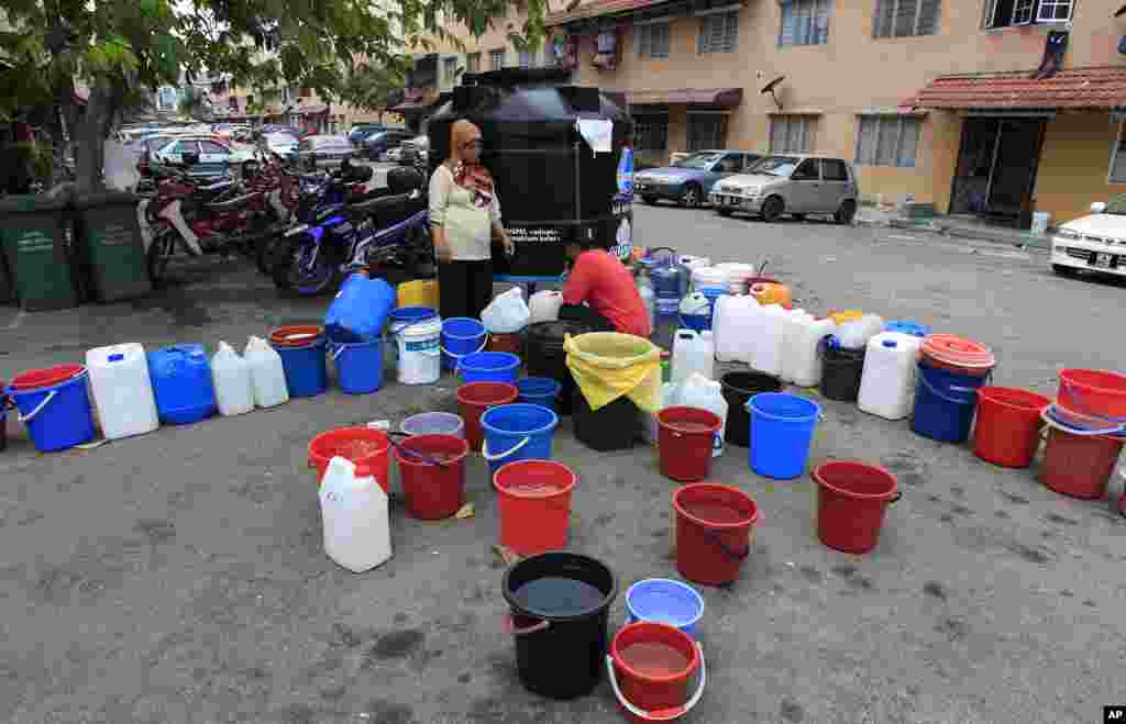 Residents collect water from a water tank in Balakong, outside Kuala Lumpur, Malaysia. Residents in some areas of Klang Valley faced water shortage caused by dams running low on water due to dry weather, according to local sources. 