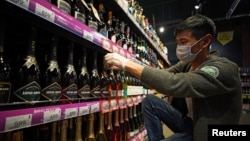 An employee arranges bottles of Russian sparkling wine at a supermarket in Moscow, Russia, July 5, 2021. 