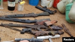 FILE - Confiscated weapons are displayed after a military raid on a hideout of suspected Islamist Boko Haram members in Nigeria's northern city of Kano, Aug. 11, 2012.