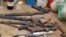 FILE - Confiscated weapons are displayed after a military raid on a hideout of suspected Islamist Boko Haram members in Nigeria's northern city of Kano, Aug. 11, 2012.