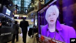 Federal Reserve Chair Janet Yellen's Washington news conference is shown on a television screen on the floor of the New York Stock Exchange, Wednesday, Dec. 16, 2015.