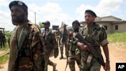 Soldiers from the 'Invisible Commandos', loyal to Ibrahim Coulibaly, walk in the PK-18 area of the Abobo neighborhood, in Abidjan, Ivory Coast, April 25, 2011