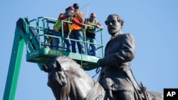 An inspection crew takes measurements as they inspect the statue of Confederate Gen. Robert E. Lee on Monument Avenue June 8, 2020, in Richmond, Va.