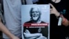 Protesters hold a placard as they attend a demonstration in support for Sea Shepherd Conservation Society Canadian founder Paul Watson, in Paris on Aug. 11, 2024.