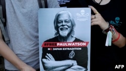 Protesters hold a placard as they attend a demonstration in support for Sea Shepherd Conservation Society Canadian founder Paul Watson, in Paris on Aug. 11, 2024.