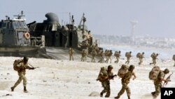 FILE - Egyptian troops come ashore from a U.S. hovercraft on the Egyptian coast near Alexandria as a part of an amphibious operation during the Bright Star maneuvers Oct. 23, 2001. 