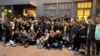 Some of the approximately 1,000 people who protested the closure of Acik Radyo on Oct. 16, 2024, pose in front of its building in Istanbul.