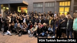 Some of the approximately 1,000 people who protested the closure of Acik Radyo on Oct. 16, 2024, pose in front of its building in Istanbul.