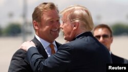 U.S. President Donald Trump is greeted by Sen. Dean Heller upon arrival in Las Vegas, June 23, 2018. The president was in Nevada to campaign for Heller.