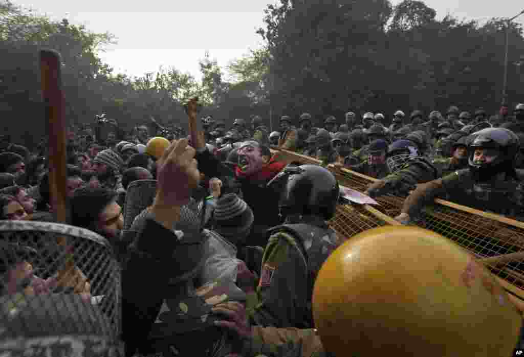 An Indian protester shouts slogans as he is stopped by police during a protest against a recent gang-rape of a young woman in a moving bus in New Delhi, India, December 27, 2012.