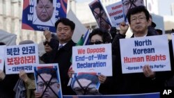 South Korean protesters and North Korean defectors hold portraits of North Korean leader Kim Jong Un during a rally near the U.S. embassy in Seoul, South Korea, urging the United States to discuss North Korean human rights issue in the upcoming Trump-Kim summit, Feb. 26, 2019.