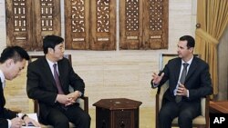 Syria's President Bashar al-Assad (R) meets Chinese Vice Foreign Minister Zhai Jun in Damascus, February 18, 2012.