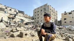 Palestinians inspect the site of an Israeli strike, in Rafah, in the southern Gaza Strip