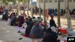 FILE - Afghan internally displaced families are pictured upon their arrival at a refugee camp in Kandahar, July 27, 2021. 