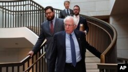 Sen. Bernie Sanders, I-Vt. (C) arrives for a closed door meeting about Saudi Arabia, Nov. 28, 2018, on Capitol Hill in Washington. In the back is Sen. Rand Paul, R-Ky., who was also arriving for the meeting. 