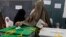 A woman casts her ballot at a polling station in Peshawar May 11, 2013.