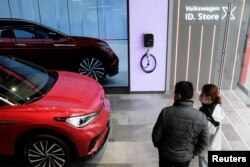 FILE - People check a Volkswagen ID.4 X electric vehicle inside an ID. Store X showroom of SAIC Volkswagen in Chengdu, China on January 10, 2021. (REUTERS/Yilei Sun/File Photo)