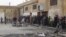 People queue to buy bread at a local bakery at Tel Abyed near Hasaka, December 17, 2012. 