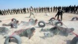Shi'ite fighters, who have joined the Iraqi army to fight against militants of the Islamic State take part in field training in the desert in the province of Najaf, Sept. 16, 2014.