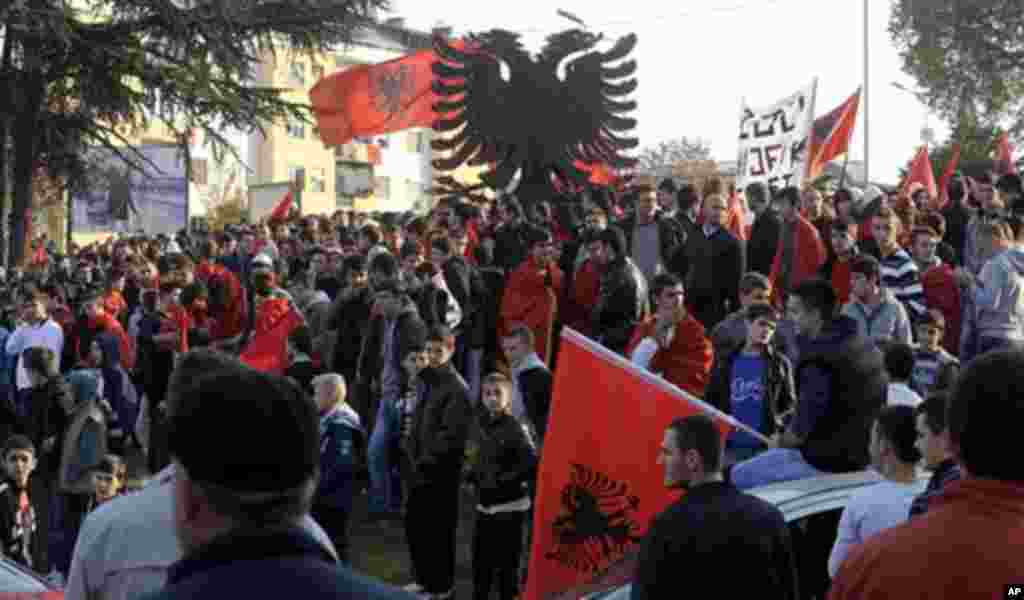 Ethnic Albanians gather at an installation of a two headed black eagle, the symbol of Albania, in Skopje, Macedonia, Sunday, Nov. 25, 2012, at the start of celebrations to mark the 100th anniversary of Albania's independence from the Ottoman empire. Some 