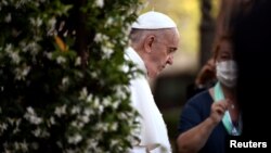 FILE - Pope Francis arrives to lead Holy Rosary prayer in Vatican gardens to end the month of May, at the Vatican, May 31, 2021.