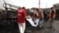 Rescue workers collect body parts after a bomb attack at Fauji Market in Peshawar, December 17, 2012.