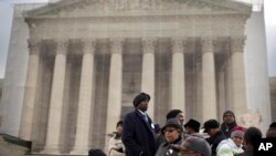 People wait in line outside the Supreme Court in Washington, Feb. 27, 2013, to listen to oral arguments in the Shelby County, Ala., v. Holder voting rights case.