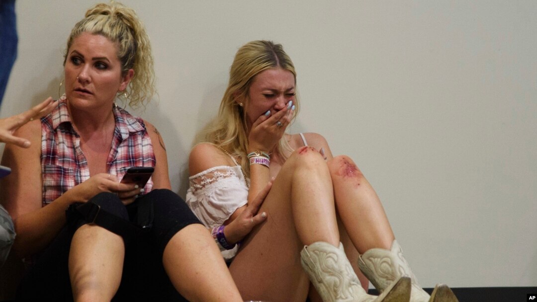A woman cries while hiding inside the Sands Corporation plane hangar after a mass shooting in which dozens were killed at the Route 91 Harvest country festival on Oct. 1, 2017, in Las Vegas. 