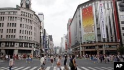 People cross a street at Tokyo's Ginza shopping district Sunday, file photo. 