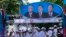 FILE PHOTO- Supporters of Prime Minister Hun Sen's Cambodian People's Party dance under portraits of the party leaders, from left, Chea Sim, Hun Sen and Heng Samrin, during an election campaign in Phnom Penh, Cambodia, Thursday, June 27, 2013. 