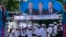 Supporters of Prime Minister Hun Sen's Cambodian People's Party dance under portraits of the party leaders, from left, Chea Sim, Hun Sen and Heng Samrin, during an election campaign in Phnom Penh, file photo. 