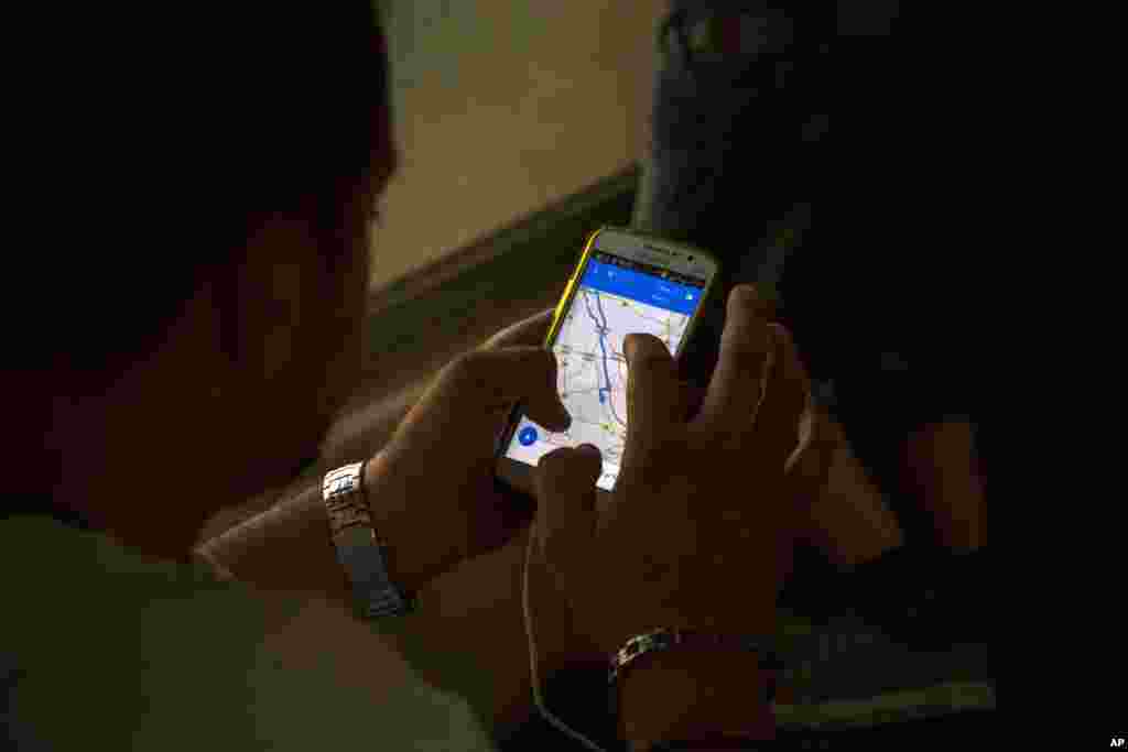 In this photo taken on Aug. 31, 2015, a Syrian refugee checks on his cell phone the distance to the Hungarian border as he travels by train from Belgrade to the northern Serbian town of Subotica. (AP)