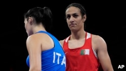 Algeria's Imane Khelif, right, walks beside Italy's Angela Carini after their women's 66-kilogram preliminary boxing match at the Summer Olympics on Aug. 1, 2024, in Paris.