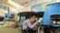 A student at Twin Lakes Elementary School in Federal Way, Washington, takes shelter under a table as she takes part in an earthquake drill, Oct. 18, 2012. 