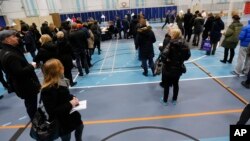 People line up to cast their vote Dec. 3. 2015 in a polling station at a public School in Copenhagen.