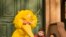 FILE - Big Bird, voiced by Caroll Spinney, reads to children during a taping of Sesame Street in New York, April 10, 2008. 