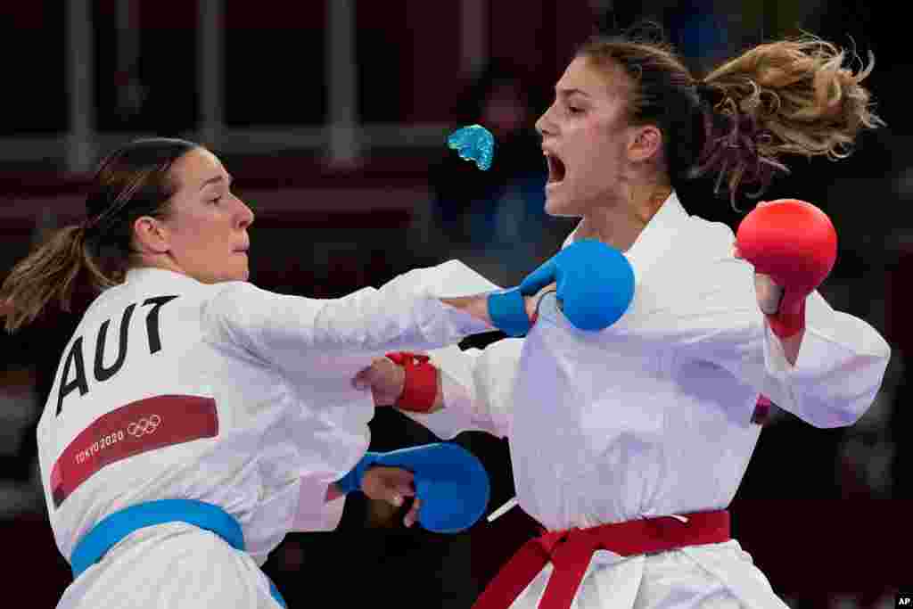 Ivet Goranova of Bulgaria, right, loses her mouth piece while competing against Bettina Plank of Austria during the women&#39;s kumite -55kg semifinal bout for Karate at the 2020 Summer Olympics in Tokyo, Japan.