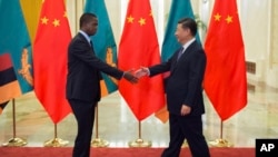 FILE - Zambia’s President Edgar Lungu, left, shakes hands with China’s President Xi Jinping, prior to their bilateral meeting at the Great Hall of the People, in Beijing, China, Sept. 1, 2018. Some are expressing concerns that Beijing is pursuing debt-trap diplomacy vis-a-vis African countries.